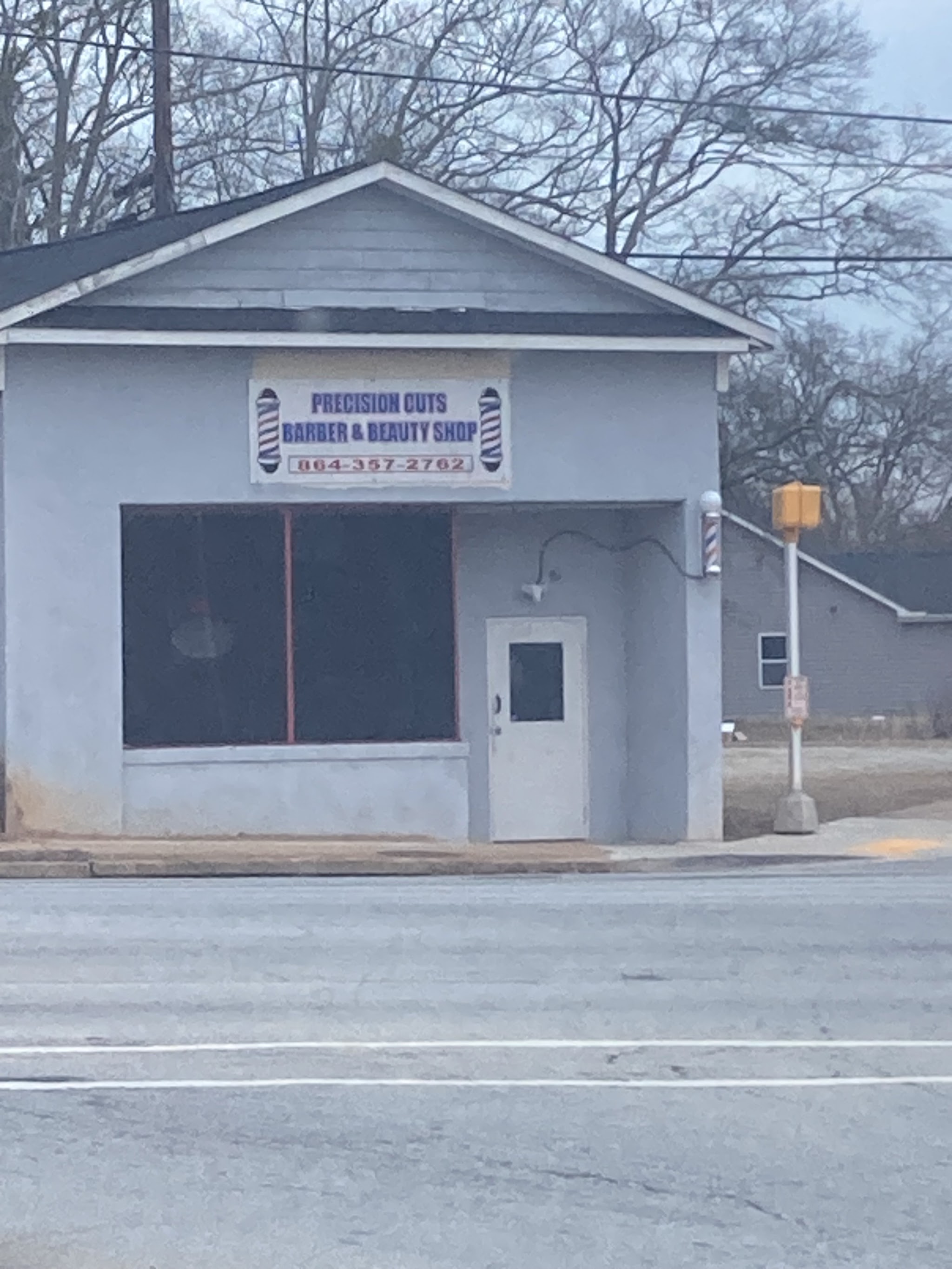 Our shop front at 811 S Church St with the barber poles and sign